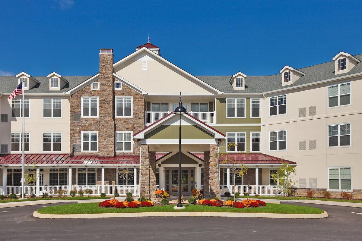 A multi-story residential building with a welcoming entrance and well-maintained landscaping.