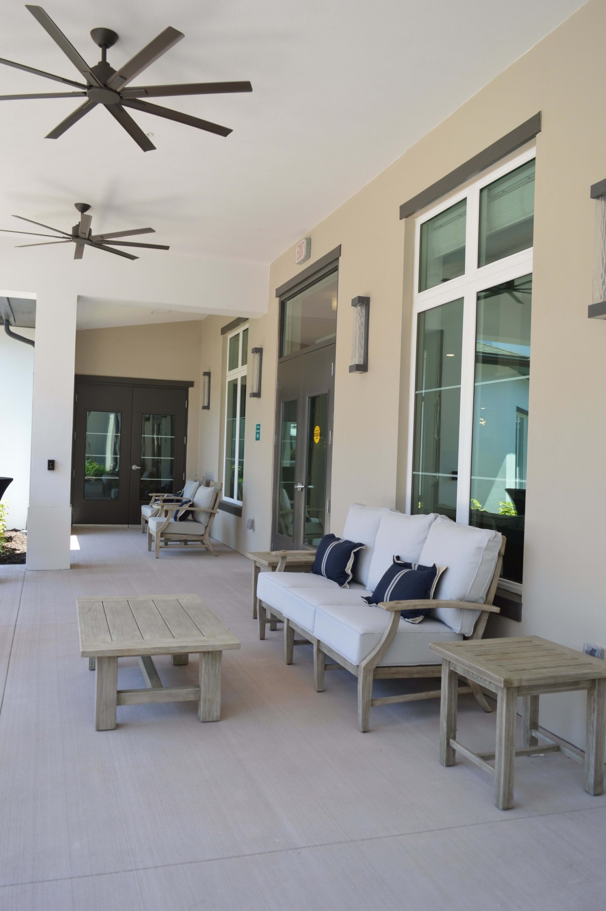 A spacious patio with comfortable outdoor seating and a ceiling fan.