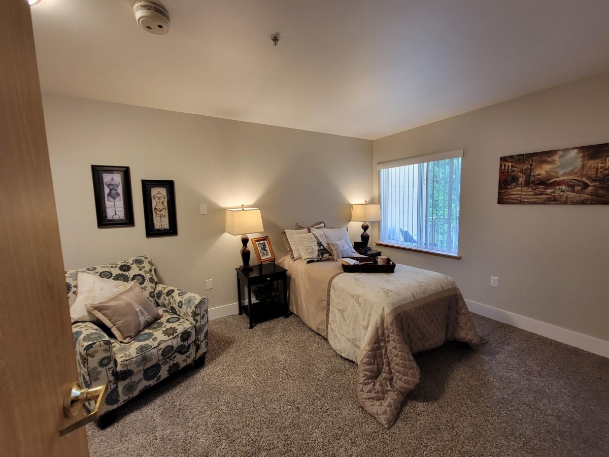 A cozy bedroom with stylish decor and warm lighting.