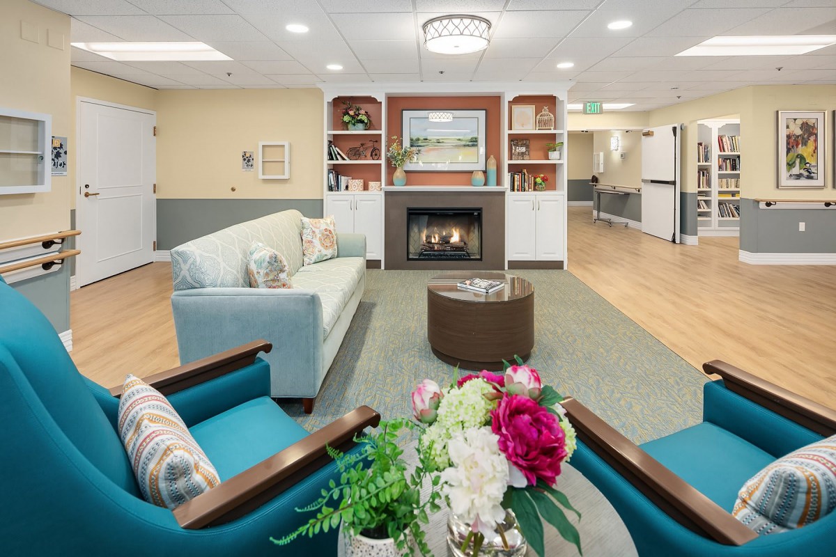 A cozy living room with a fireplace, comfortable seating, and decorative elements.