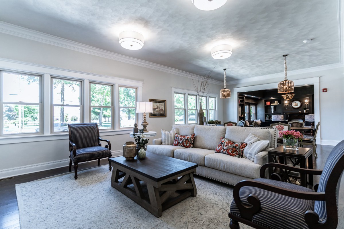A spacious and well-lit living room with comfortable seating and modern decor.