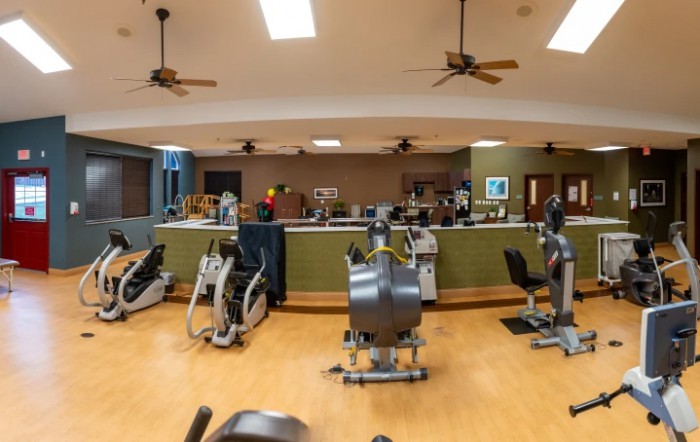 A spacious gym interior with various exercise machines and fitness equipment.