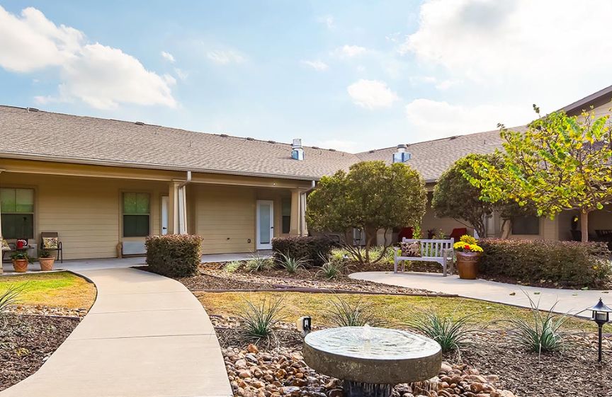 A serene courtyard with outdoor seating and landscaped garden.