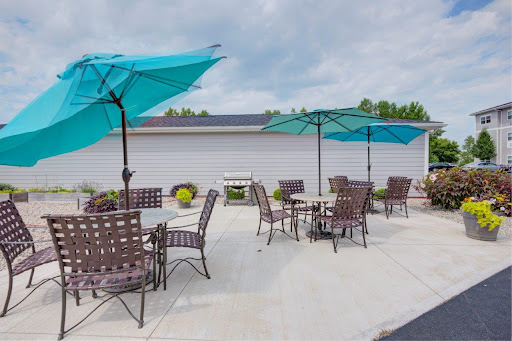 A cozy outdoor patio area with turquoise umbrellas and comfortable seating, perfect for relaxation.