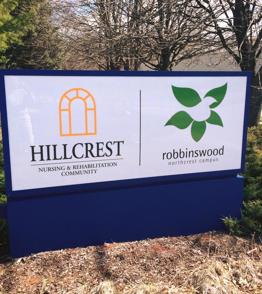 A sign for Hillcrest Nursing & Rehabilitation Community and Robbinswood Assisted Living Community.