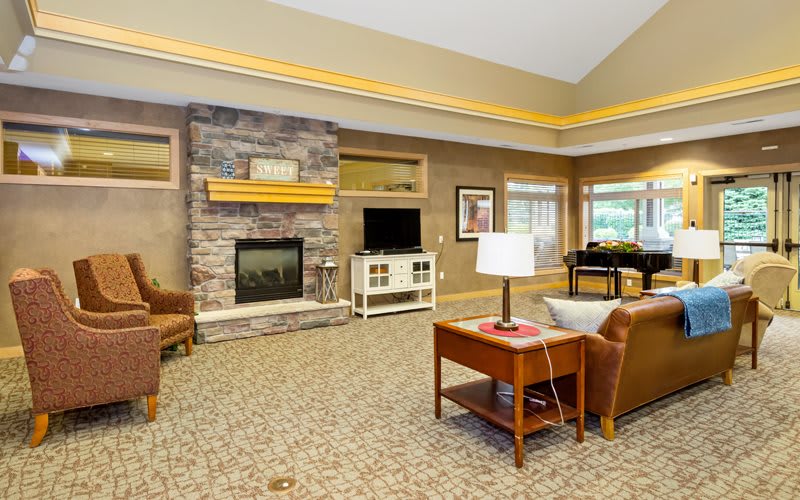 A cozy living room with a fireplace, television, and comfortable seating.