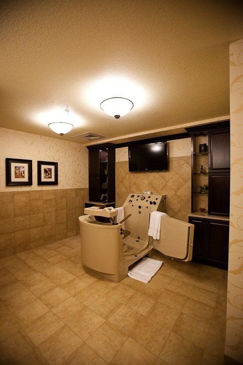 A luxurious spa room featuring a comfortable massage chair and elegant interior design.