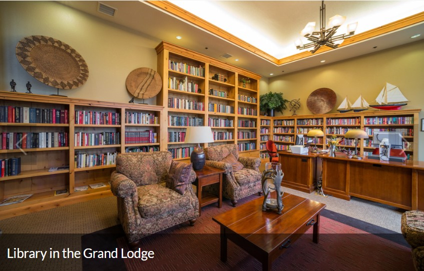 A cozy library corner with bookshelves and comfortable seating.