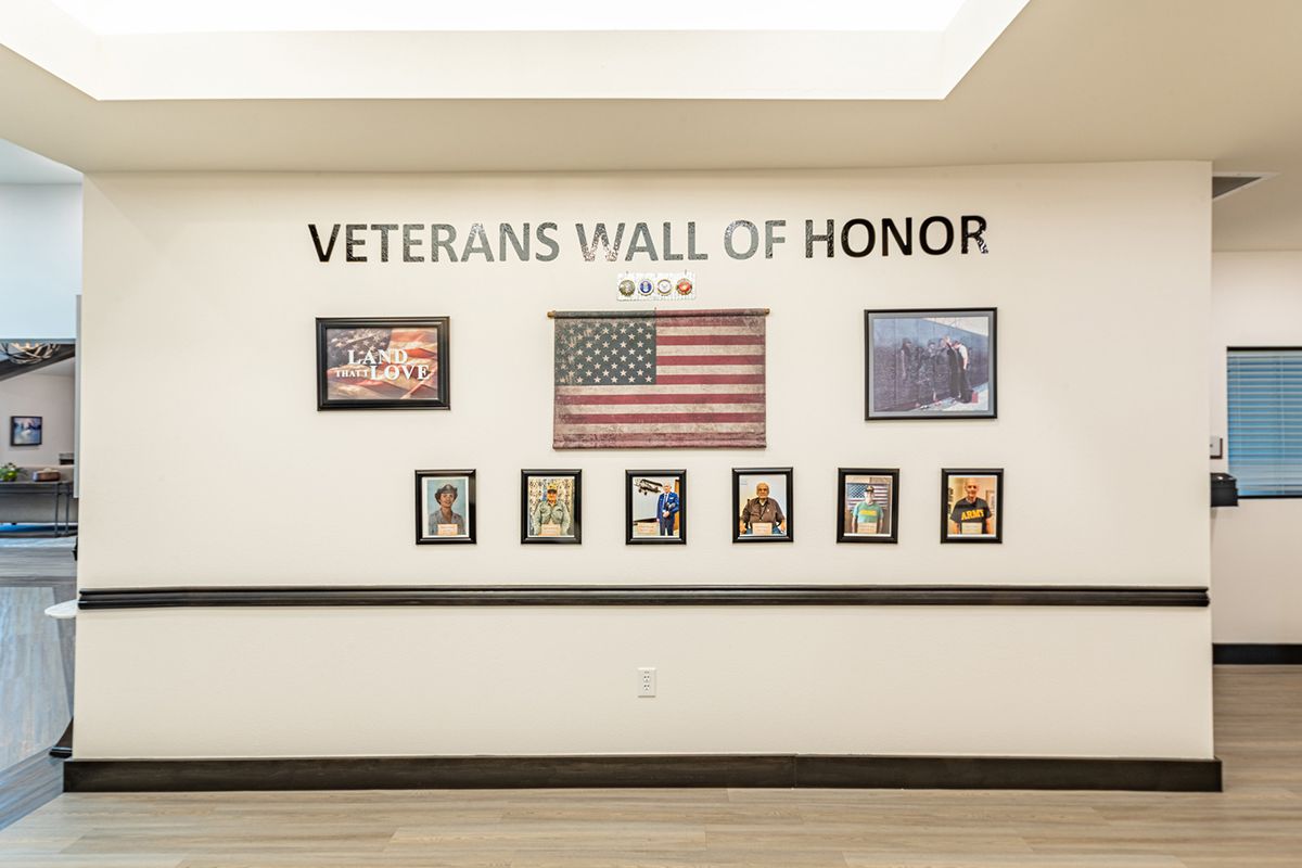 A Veterans Wall of Honor displaying the American flag and photographs of military personnel.
