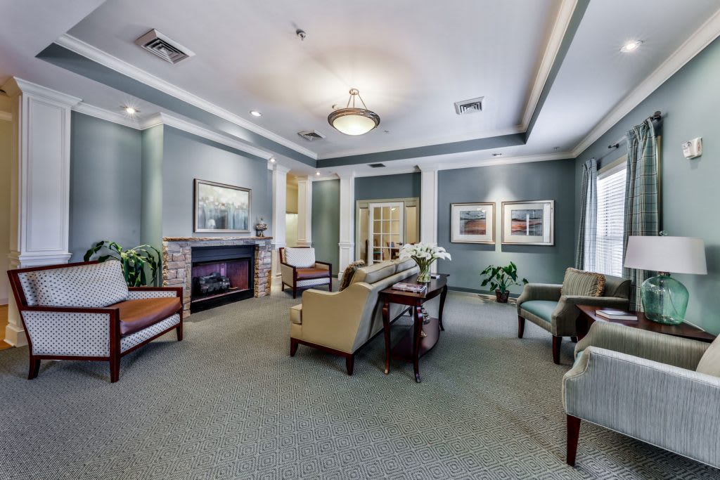 A well-decorated living room with comfortable seating and a fireplace.