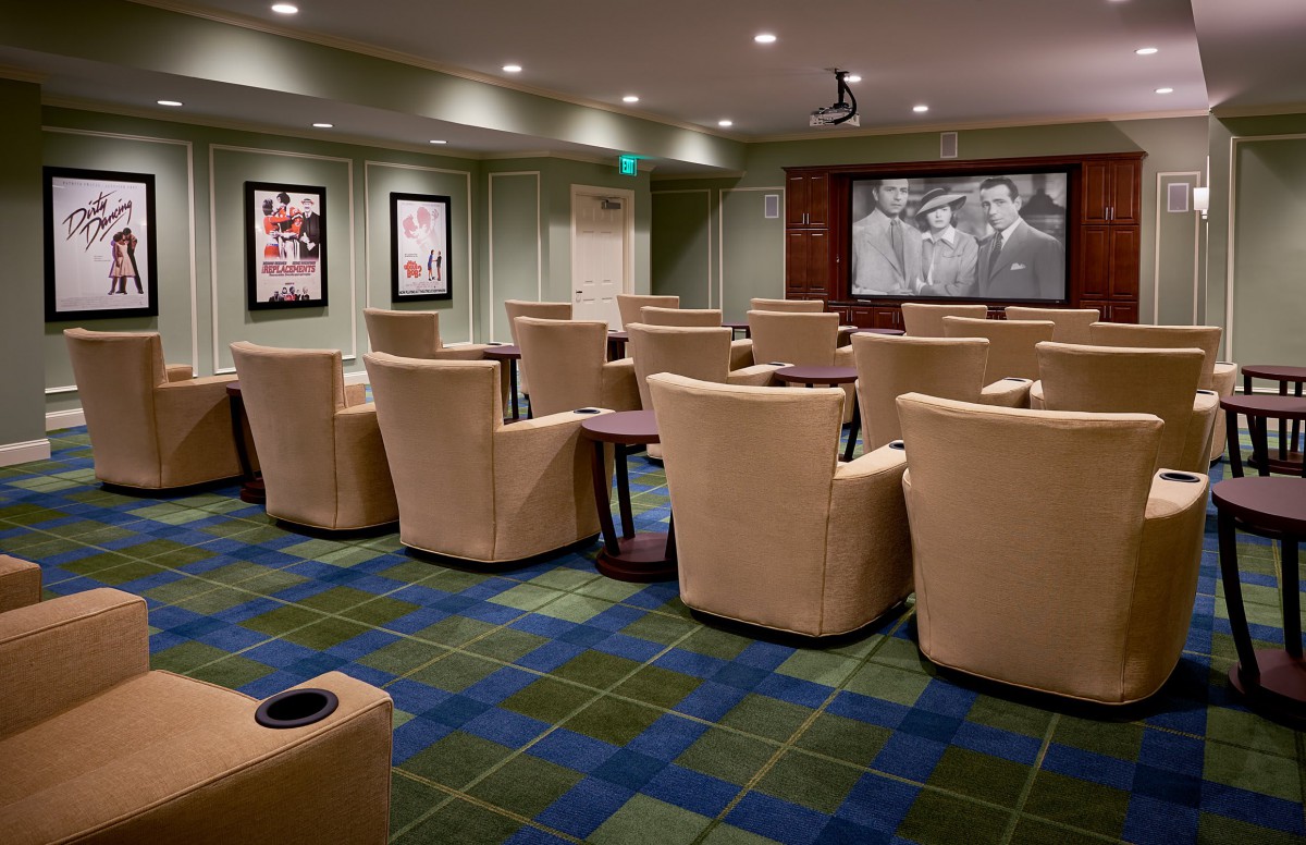A cozy home theater with plush seating and a large screen for viewing movies.