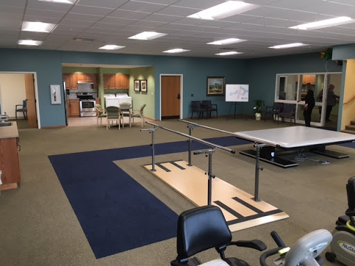 A spacious physical therapy room equipped with a rehabilitation walkway and exercise areas.