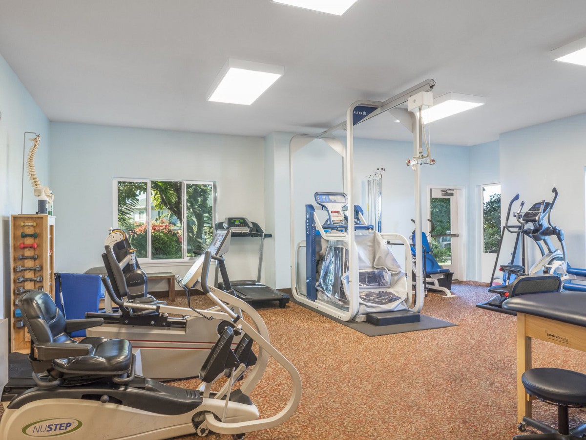 A well-equipped gym with various exercise machines and equipment.