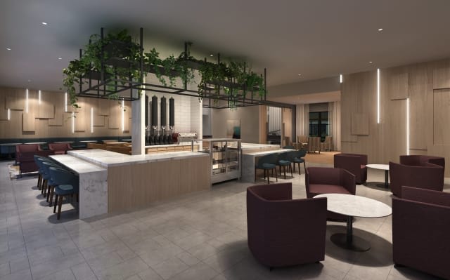 A modern lounge area with minimalist furniture and greenery accents.