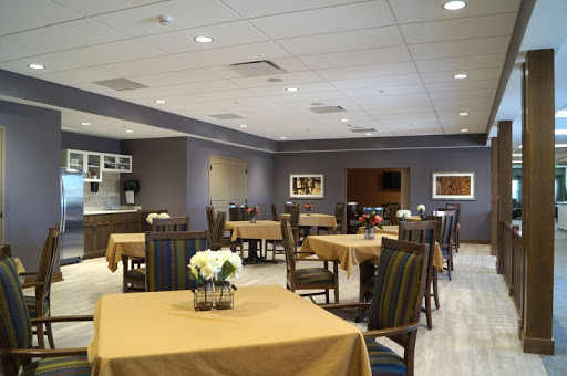 A spacious and welcoming dining area featuring elegantly set tables and comfortable seating.