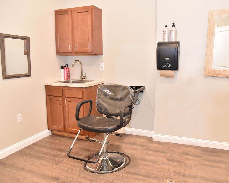 A salon interior featuring a barber chair and sink setup.