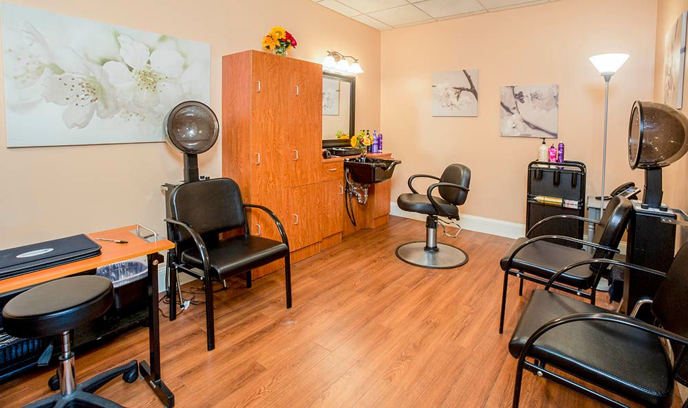 A cozy hair salon with styling chairs and mirrors.