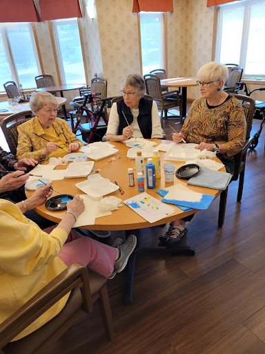 Seniors engaged in a creative activity at a community center.