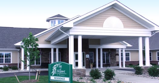 The front entrance of a residential building with a sign reading 'The Willows'.