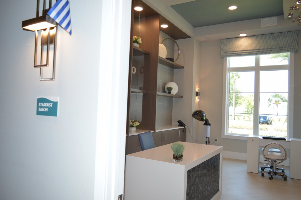 A modern office interior with a desk and decorative shelves.