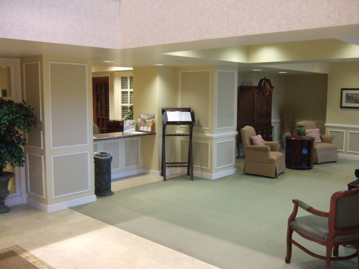 A cozy lobby with a reception desk and comfortable seating area.