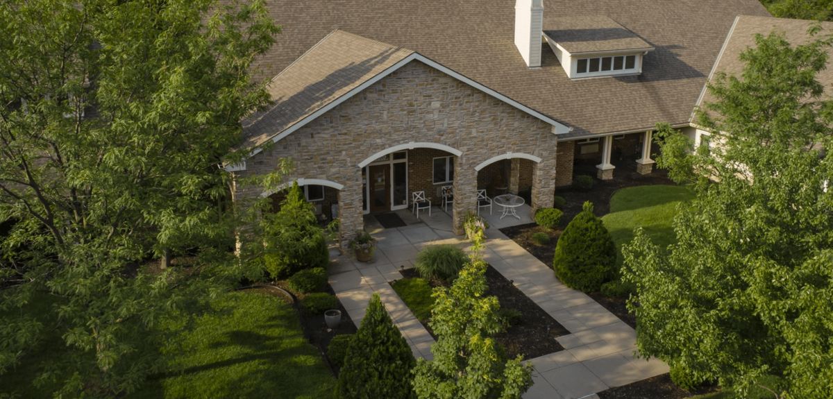 A suburban house with a stone facade and well-maintained landscaping.