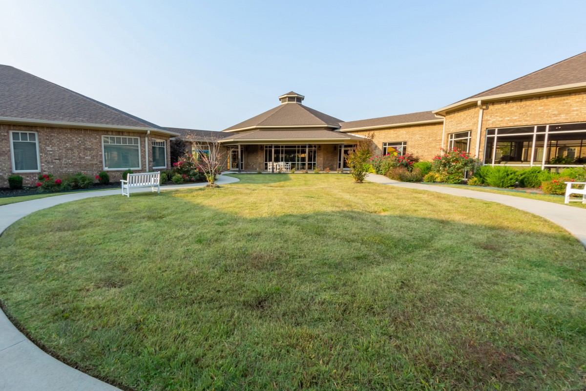 A spacious house with a well-maintained lawn and garden.