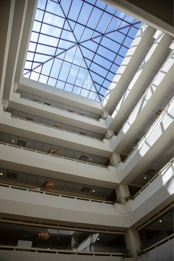 A modern atrium with multiple floors and a skylight ceiling.