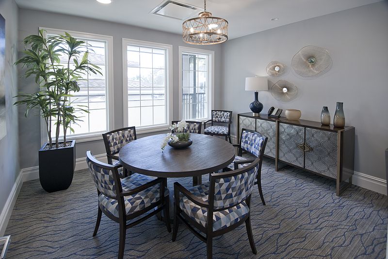 A stylish dining room with a round table and decorative elements.