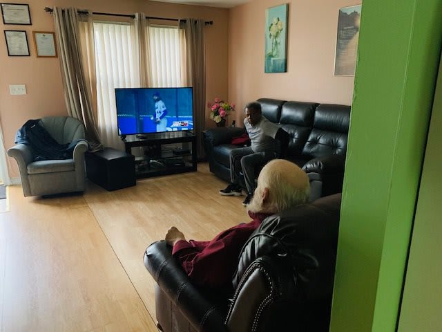 Two people watching TV in a cozy living room.