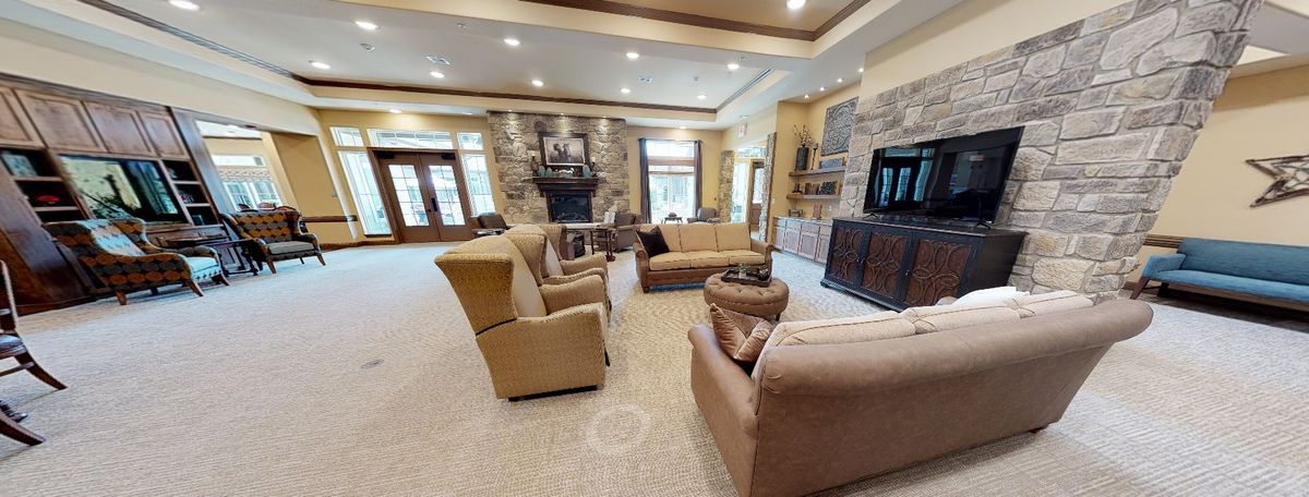 Spacious living room with comfortable seating, a fireplace, and modern decor.