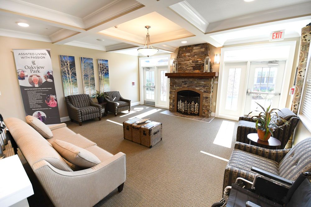 A cozy living room featuring a stone fireplace, comfortable seating, and elegant decor.