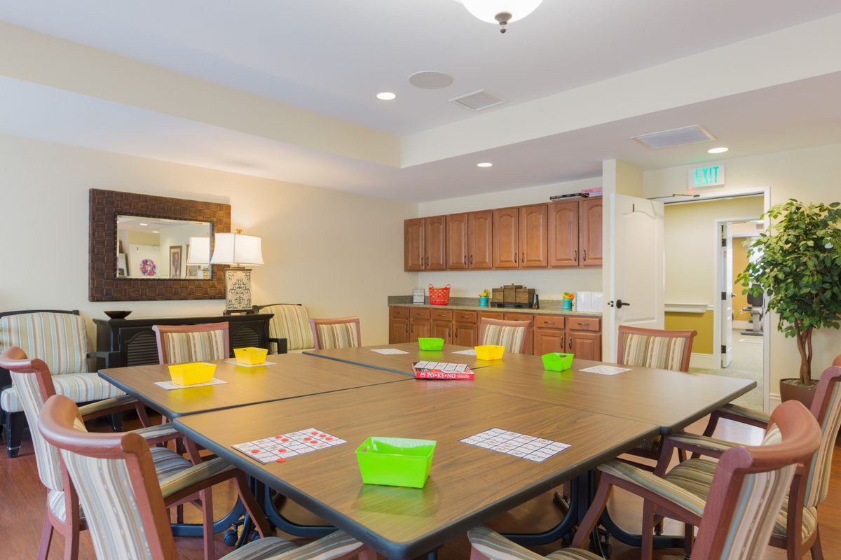 A well-lit meeting room equipped with a large table and chairs, ready for a conference or group discussion.