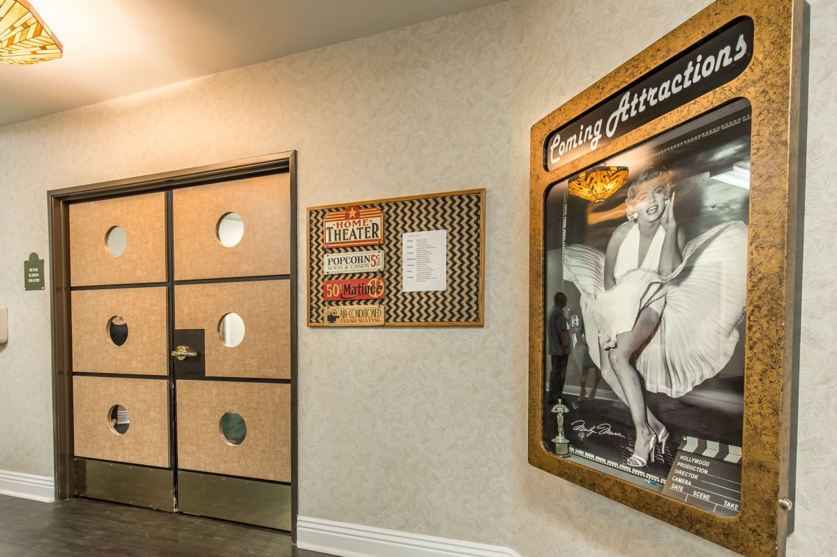A hallway featuring an art deco-style vintage poster depicting a theater scene.