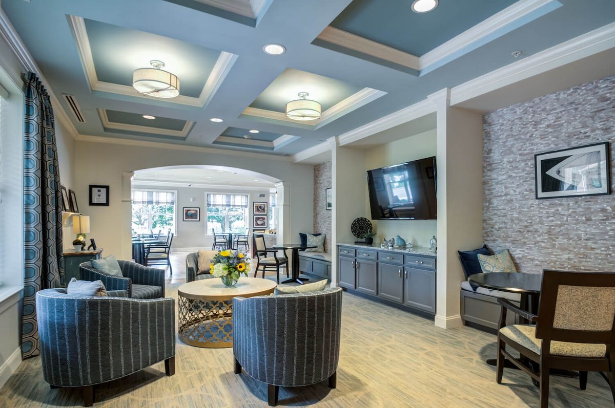 A modern and cozy living room with comfortable seating and a large television.
