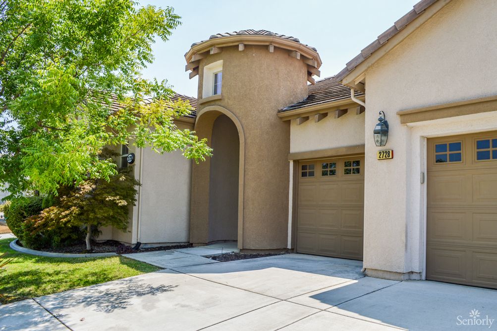 Front view of a modern residential house with a garage and driveway.