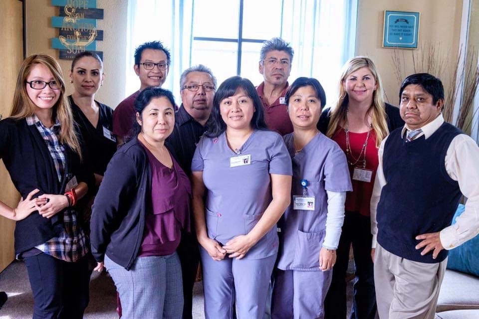A group of professionals posing together inside a building.