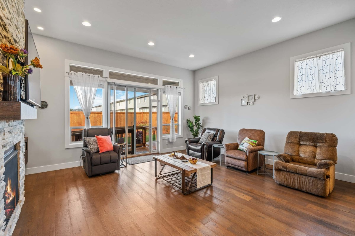 A spacious and bright living room with modern decor and large windows.