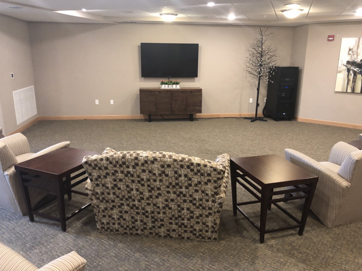A cozy living room setup with a TV, couch, and modern furniture.