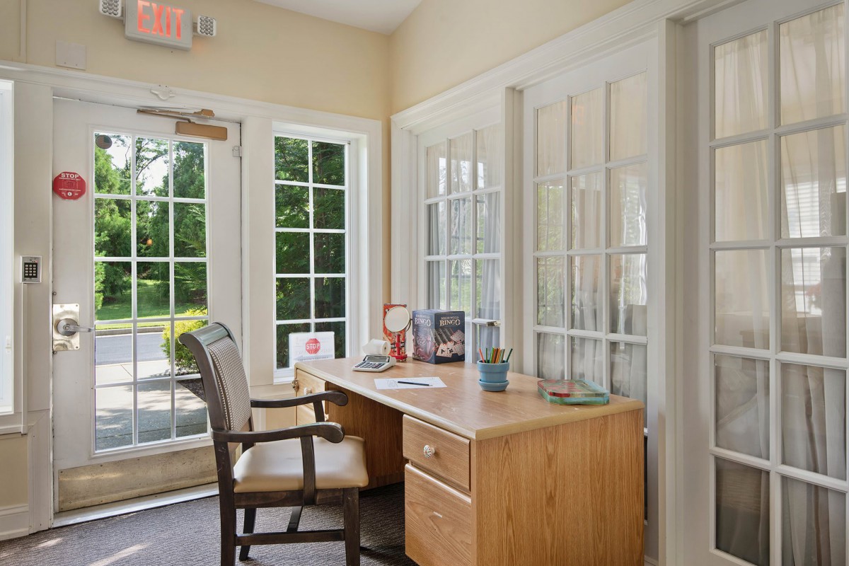 A bright office space with a desk and chair by the window.