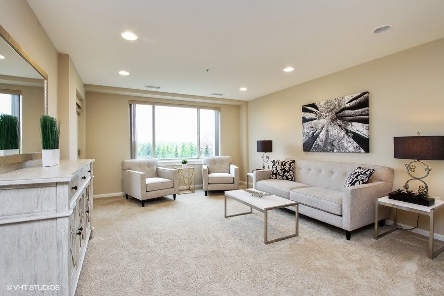 A modern living room with neutral tones and elegant decor.