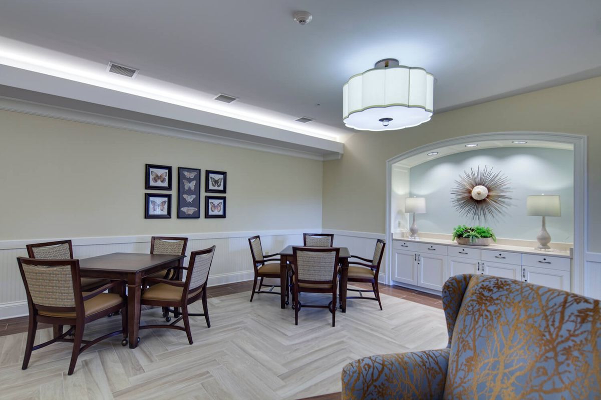 A modern dining area with elegant furniture and soft lighting.
