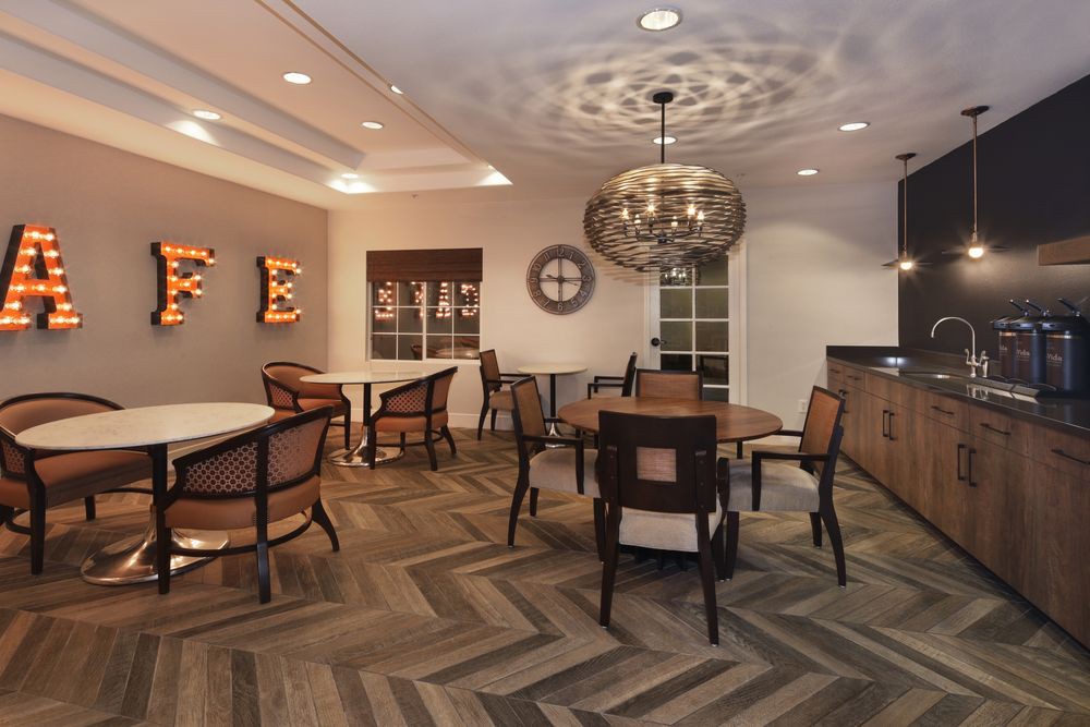 A modern dining room featuring stylish furniture and ambient lighting.