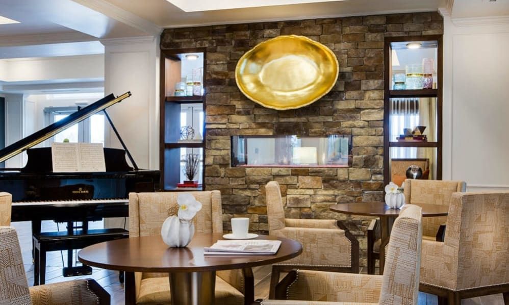 A modern living room with a stone accent wall, featuring elegant furniture and decorative elements.