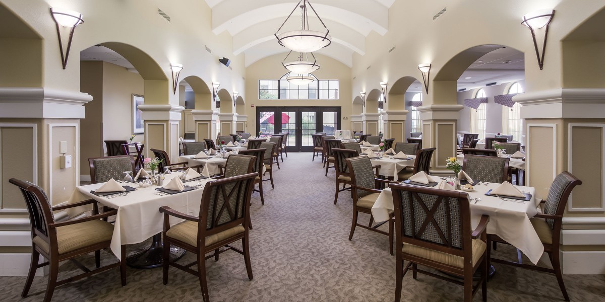 An elegant dining room with neatly arranged tables and soft lighting.