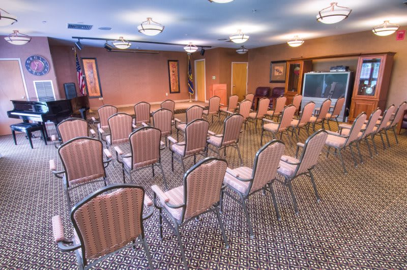 An empty conference room set up with rows of chairs for a meeting or event.