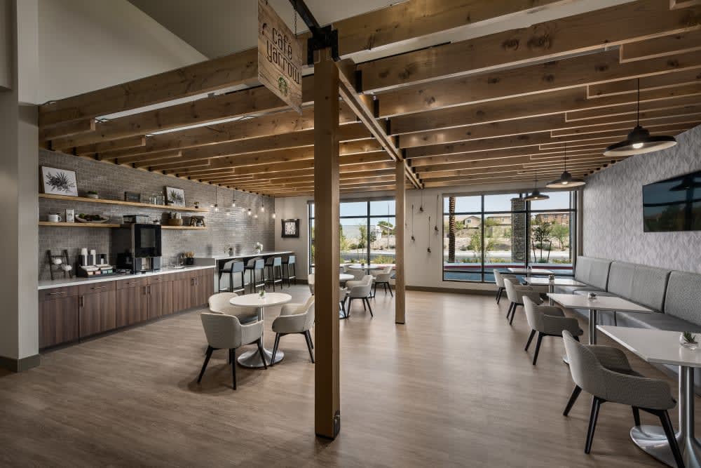 A modern restaurant interior with wooden beams and natural lighting.