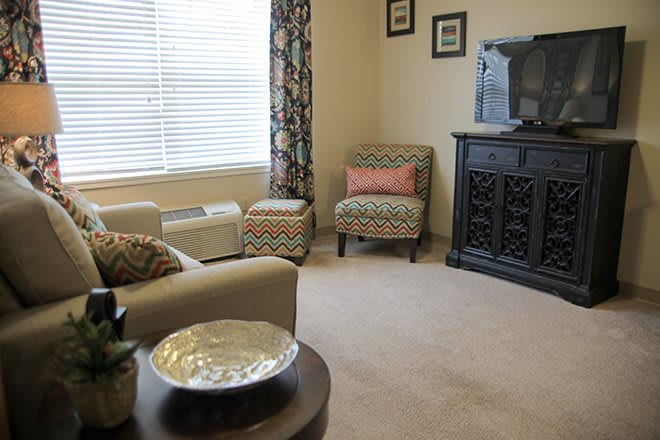 Cozy living room with patterned armchair and elegant decor.