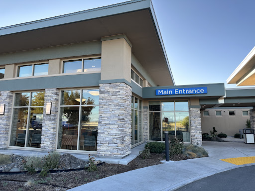 A modern office building featuring large windows and a welcoming entrance.