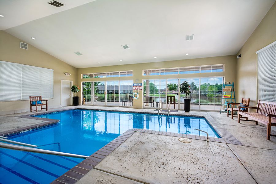 An inviting indoor swimming pool with large windows and ample natural light.